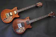 Two Brown Roland G-303 Guitars